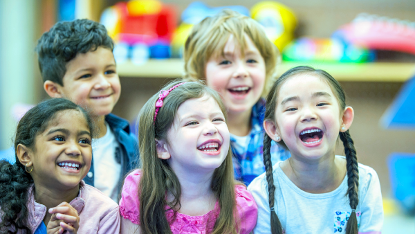 Happy children are indoors, highlighting the need for indoor air quality detectors to ensure safe and healthy air in classrooms