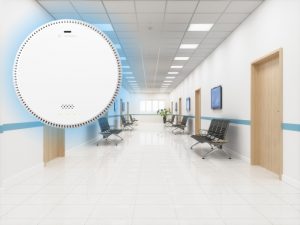 Air quality monitor in a hospital corridor to detect airborne contaminants for compliance with health regulations.